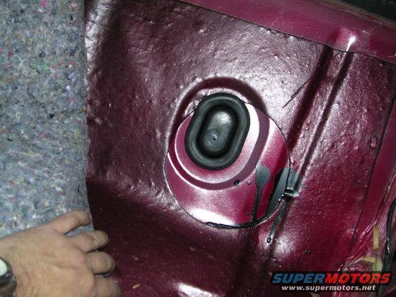Interior panel with rubber grommet and sound deadening material