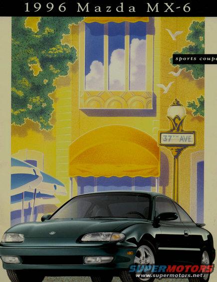 Green 1996 Mazda MX-6 sports coupe parked on a street with a yellow building and a 37th Ave sign