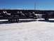 1994 Ford Bronco - A pickup truck tows a trailer loaded with multiple snowmobiles through a snowy area.