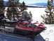 1994 Ford Bronco - A red Polaris Sport Touring snowmobile sits in the snow, with a scenic winter landscape behind it.