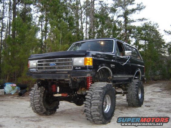Black lifted Ford Bronco with large off-road tires, front 3/4 view