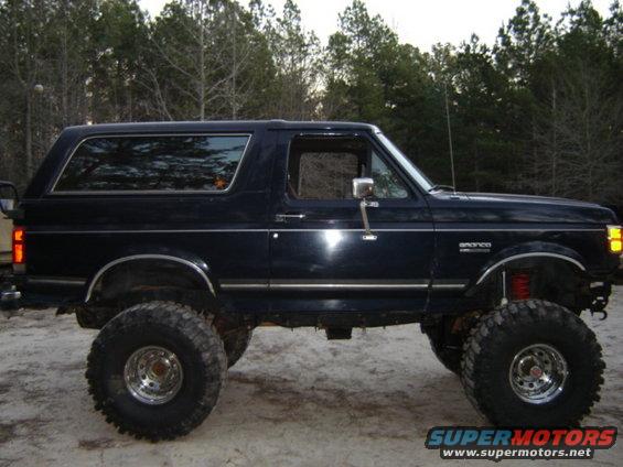 1989 Ford Bronco lifted with large off-road tires, side view