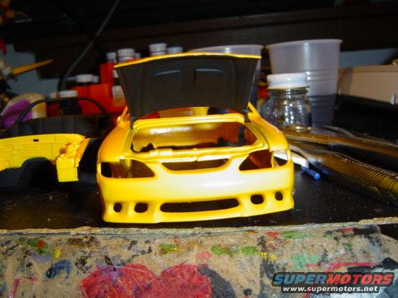 Yellow model car front view, hood open