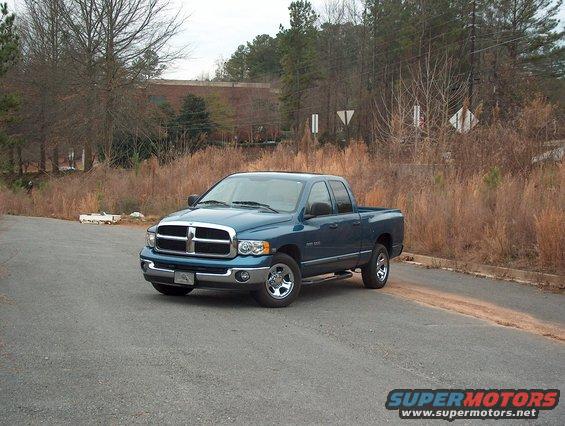Blue 2004 Dodge 1500 pickup truck parked on asphalt