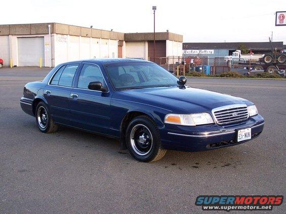 Blue sedan parked on asphalt, front quarter view. License plate reads 523-NUK
