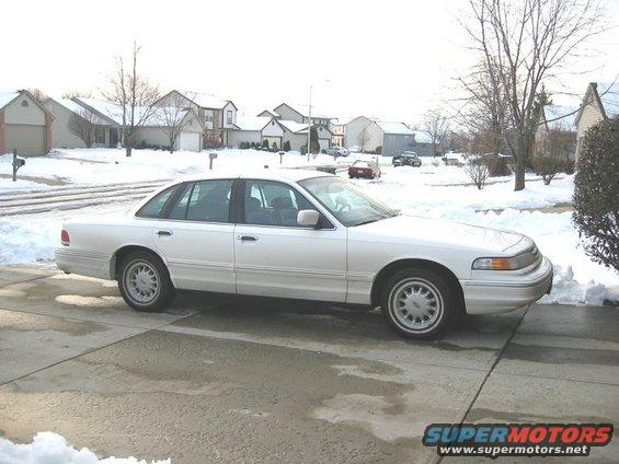 White 1997 Ford Crown Victoria parked in a snowy driveway