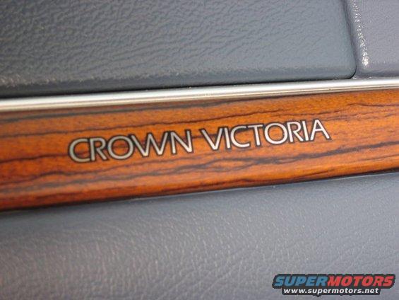 Crown Victoria emblem on wood trim inside a vehicle