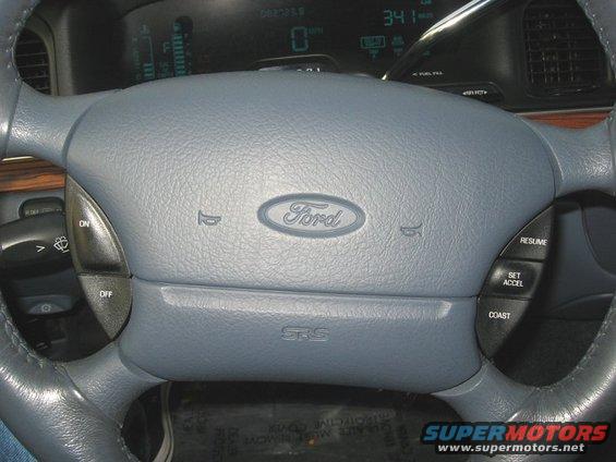 Gray steering wheel with Ford logo and cruise control buttons. Digital dashboard shows 341
