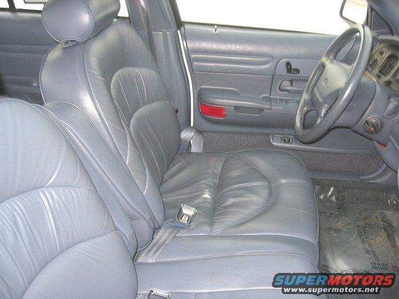 Gray leather interior of a 1997 Ford Crown Victoria, showing front seats and dashboard