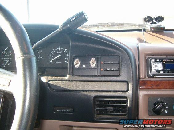 1996 Ford Bronco interior dashboard with steering wheel, tachometer, overdrive shifter, and 4x4/low range switches