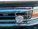 1996 Ford Bronco - The Ford emblem and grille design are consistent with a 1996 Bronco, complemented by a KC light and chrome grille guard.