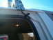 1996 Ford Bronco - Close-up of a KC light bar installation on the roof of a vehicle, showing wiring and mounting details.