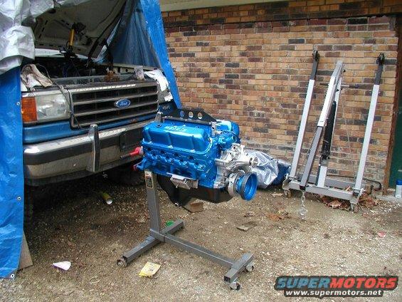 Blue engine on stand, truck in background