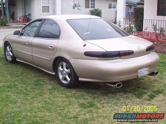 Gold 1998 Mercury Sable rear view with dual exhaust tips