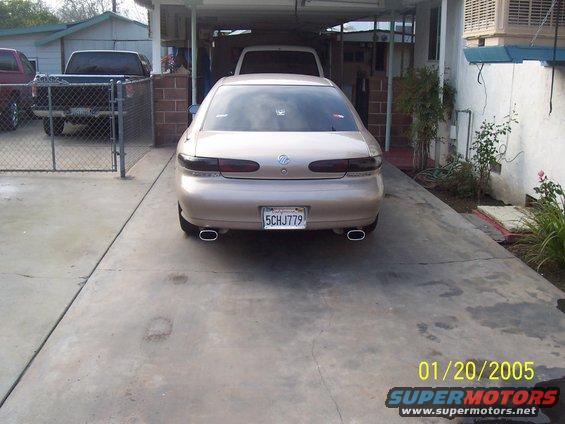 Tan 1998 Mercury Sable sedan rear view with dual exhaust tips and license plate 5CHJ779