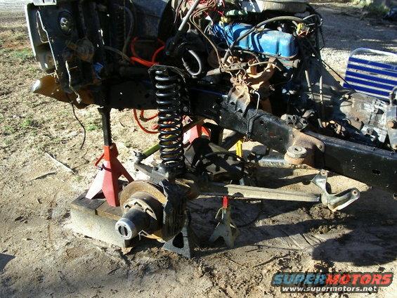 vehicle frame on jack stands, engine and front suspension exposed