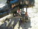 1985 Ford Bronco - The front end of a vehicle is disassembled, showing the engine and suspension components.