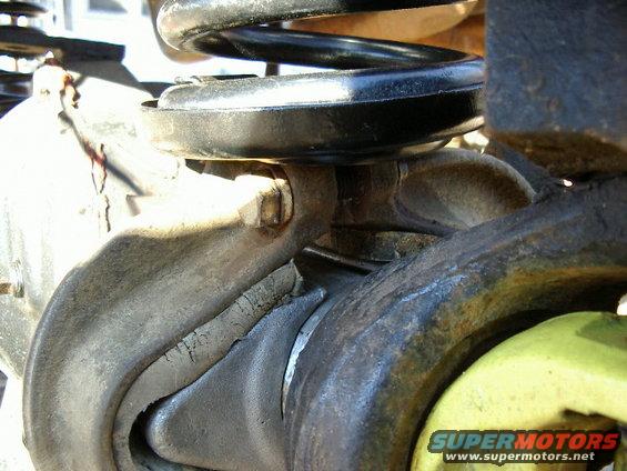 Close-up of vehicle suspension with a coil spring and metal components