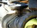 1985 Ford Bronco - This image shows a close-up view of a vehicle's suspension system, focusing on the coil spring and surrounding metal parts.