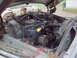 1979 Ford Bronco - The engine compartment of an older vehicle shows its mechanical components, including the carburetor and radiator.