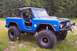1974 Ford Bronco - Modified 1974 Ford Bronco sits in a grassy field, ready for off-road adventures.
