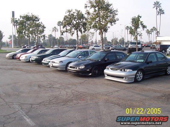 Silver and black sedans parked in a lot, front view. Date stamp shows 01/22/2005