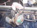 1988 Ford Bronco - Power steering pump removed from a vehicle, shown in a truck bed with a rag.