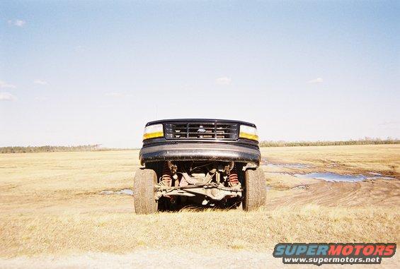 Front view of a lifted 1997 Ford F-250 with aftermarket suspension components visible