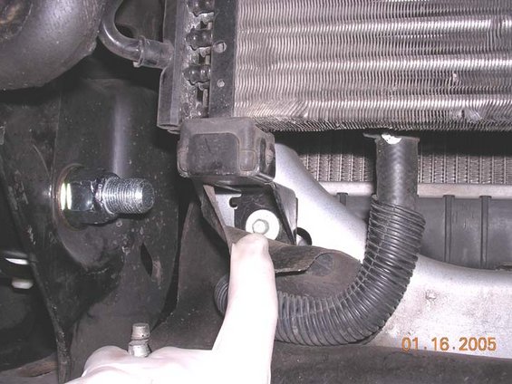 condensersupport.jpg I FUBARed the first bolt.  Not sure if it was the beers or just plain stupidity, but I missed that there was a bolt on this bracket.  it was in the way of the front leaf spring bolt and wouldnt allo the bolt to be removed.  so like an idiot I cut it out, which requied reaming the leafspring eye out to 3/4" to fit a standard 3/4" bolt instead of fords metric crap.