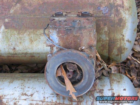 Rusted air compressor part with leaf debris