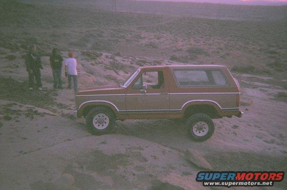 Brown and tan 1983 Ford Bronco on rocky terrain