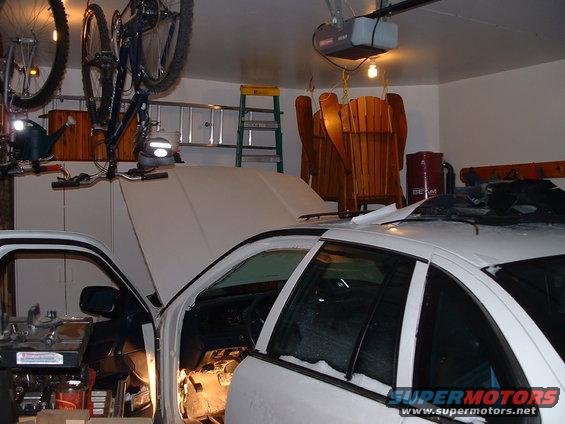 White 1996 Ford Crown Victoria with hood open, interior visible, parked in a garage