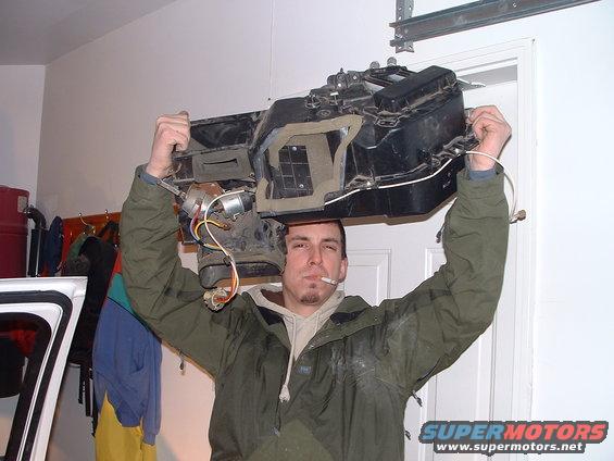 HVAC assembly with motor and wires held above man's head