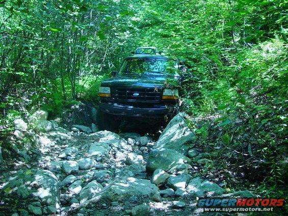 Front view of black 1995 Ford Bronco on rocky trail