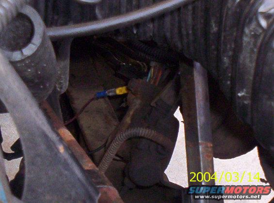 Heres a shot of the proportioning (sp?) valve.  Its where the lines from the MC run to.  It shouldn't be hard to find.  I found it easier going from the bottom.  I'm not sure of an easy way to take all the fluid out.. Probably just start at the back, loosen the bleeder valve, and just keep pumping the brakes.  I didn't think that far ahead though =)