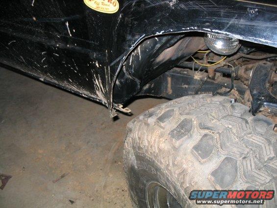 Black 1986 Ford F-150 fender and large off-road tire