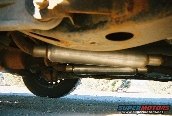 Underbody view of dual exhaust mufflers and suspension components