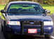 1998 Ford Crown Victoria - Front view of a dark blue Ford Crown Victoria, likely a police car, with a push bar.