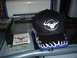 1993 Ford Taurus - A black baseball cap with a bull logo and flame accents sits on a glass table next to a sticker and a printer.