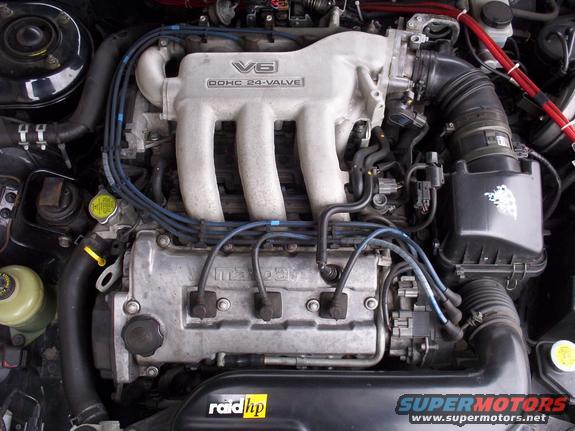 Close-up of a Mazda V6 engine with DOHC 24-valve labeling on the intake manifold