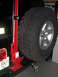 2004 Jeep Wrangler - All-cast (red) hi-lift custom mounted to Warn tire carrier