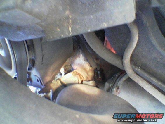 Engine components with rust and fluid leaks, close-up view