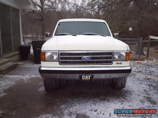 1989 Ford Bronco front view, covered in ice with icicles hanging from bumper and windshield