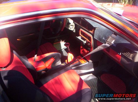 Red car interior with two-tone seats and dashboard