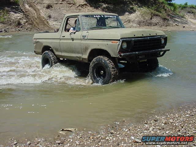 Ford F-Series truck driving through water. Text on windshield reads "EAGLE OFFROAD"