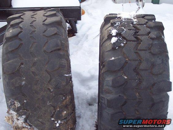 two large off-road tires in snow