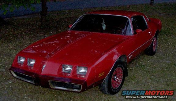 Red 1979 Pontiac Firebird parked on grass