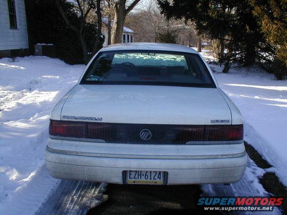 Rear view of a white Mercury Grand Marquis LS parked in the snow. License plate EZH-6124