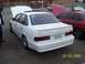 2002 Ford Taurus - White Ford Taurus SHO with custom license plate 'GOOF SHO' and aftermarket wheels.