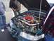 2002 Ford Taurus - The engine bay of a 2002 Ford Taurus, a modified intake system and custom engine components.
